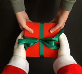 Santa giving a Xmas present to a kid.