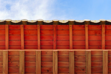 bright red wooden canopy after restoration with patterns on a clear sunny day against a blue sky © Александр Коновалов
