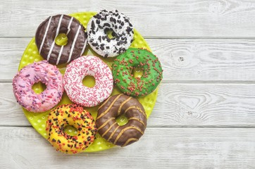 Colorful sweet cakes. Donuts with a hole with different toppings and decorations.