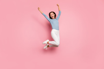 Turned full length body size photo of cheerful positive crazy excited girl rejoicing in having achieved all aims planned before jumping isolated pastel color background