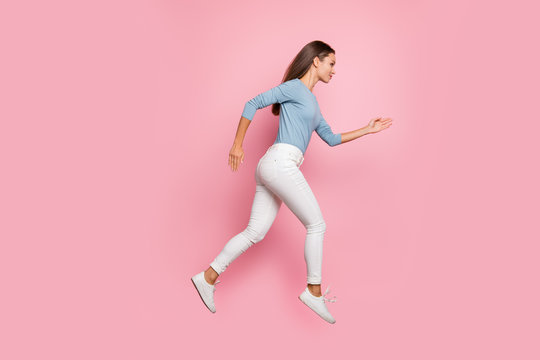 Full length body size side profie photo of focused confident girl running jumping to her aim isolated pastel color background