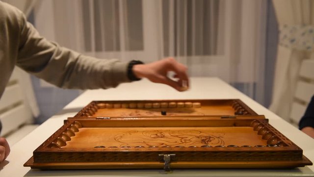 Beginning of a backgammon game with a player who throw dices on board