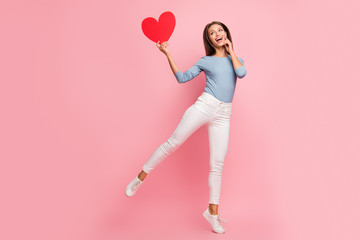 Fototapeta na wymiar Full length body size photo of cheerful positive charming pretty girl excited about being gifted big red heart shape in blue sweater isolated pastel color background