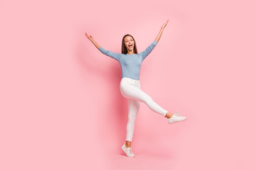 Fototapeta premium Turned full length body size photo of pretty sweet cute charming woman throwing her leg with hands up screaming rejoicing in having rest isolated pastel color background