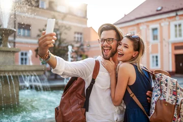 Foto op Plexiglas Happy tourist couple in love having fun, travel, smiling on vacation © NDABCREATIVITY