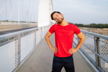 Man runner taking a break during training outdoors. Jogger resting after running.