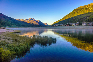 Mountain lake panorama with mountains reflection. Idyllic look. Autumn forest. Silvaplana Lake, Switzerland