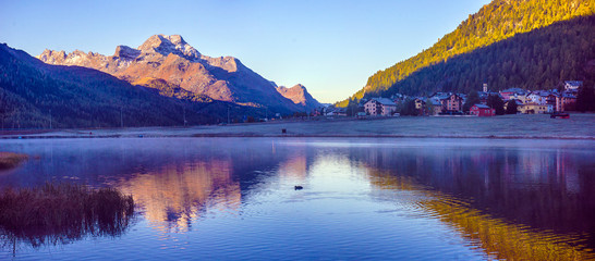 Mountain lake panorama with mountains reflection. Idyllic look. Autumn forest. Silvaplana Lake, Switzerland