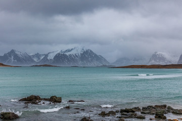 sunset under blue hour over fjord in polar night on Lofoten islands, Norway.