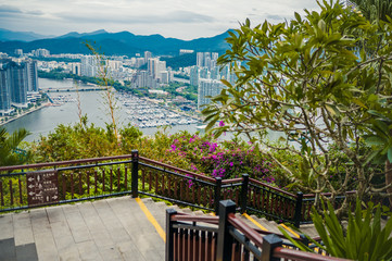 Top View of Hainan's Sanya City from the Luhuitou park, with local houses and luxury hotels and buildings. Summer Vacation Paradise in Asia.