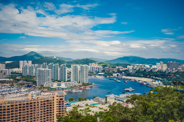 Top View of Hainan's Sanya City, with local houses and luxury hotels and buildings. Summer Vacation...