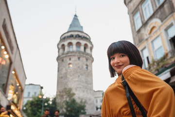 Fototapeta na wymiar Beautiful woman stands in front of Galata tower