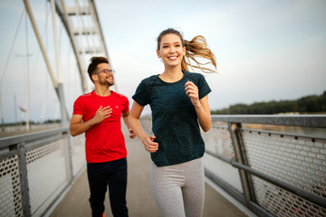Obraz premium Young people running and exercising. Living healthy sporty lifestyle