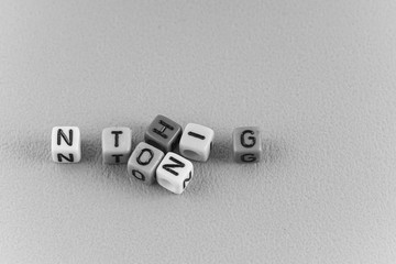 A word NOTHING made by a colourful cube beads alphabet . Black and white concept
