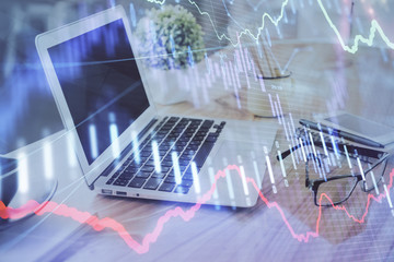 Forex Chart hologram on table with computer background. Double exposure. Concept of financial markets.