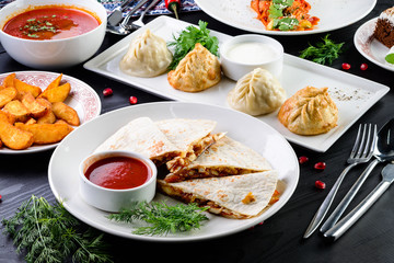 Assorted Uzbek food set, pilaf, samsa, lagman, manta and Korean carrots, set of uzbek food