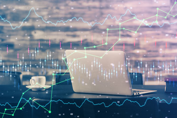 Financial graph colorful drawing and table with computer on background. Double exposure. Concept of international markets.