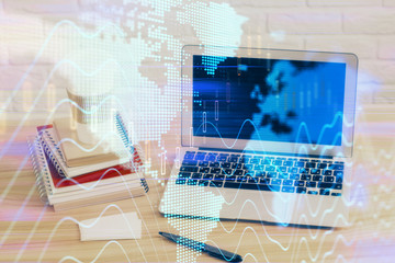 Forex market graph hologram and personal computer on background. Double exposure. Concept of investment.