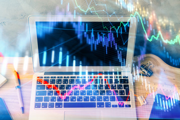 Multi exposure of chart and financial info and work space with computer background. Concept of...
