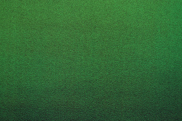 Green color plastic glittering texture with blur effect.