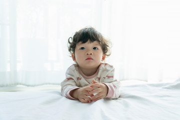 Portrait of little boy playing in the bedroom.