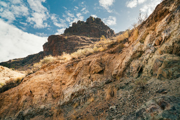Rocky volcanic mountains on Gran Canaria island in tropical Canary island, Spain in Atlantic ocean. Scenic mountains rising above winding roads
