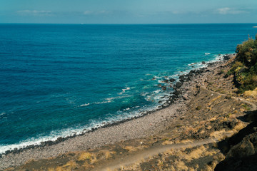 View of the black beach Playa de Guayedra in Las Palmas on Gran Canaria volcanic island, Spain, Atlantic ocean, volcanic rocks