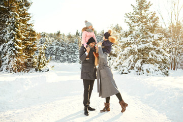 Family smiling in winter in a park