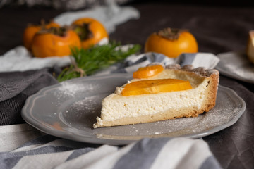 original persimmon cheesecake. Beautiful dessert on a gray background. New Year. Christmas. Halloween Thanksgiving Day