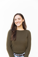 Obraz premium Happy joyful Latin woman posing for camera, smiling and laughing. Young woman in casual standing isolated over white background. Good news or positive emotions concept