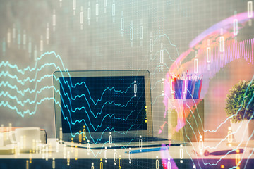 Financial market graph hologram and personal computer on background. Double exposure. Concept of forex.