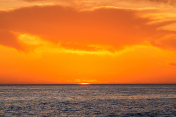 Fototapeta na wymiar Caspian Sea at sunset. The sun sets in the water.