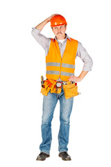 Portrait of a male builder in a helmet  looking at camera over white wall background. repair, construction, building, people and maintenance concept.