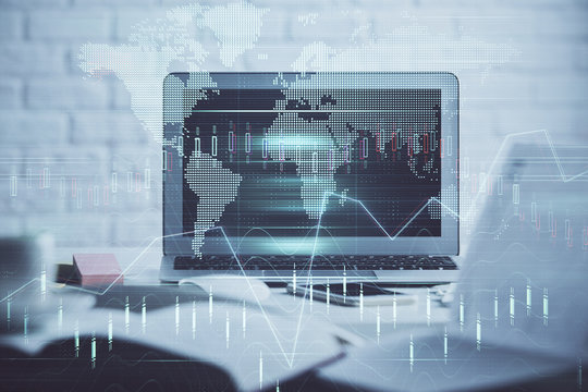 Financial graph colorful drawing and table with computer on background. Double exposure. Concept of international markets.