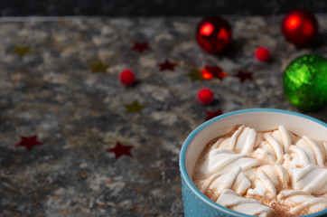 Christmas and New Year cozy holiday composition with mugs with cocoa or chocolate, marshmallow,  and red berry on the dark background. 