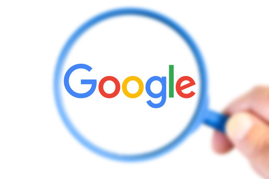 Google logotype enlarged with a magnifying glass
