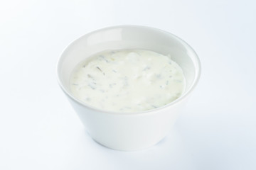 cream sauce with pickles in a bowl on a light background, mayonnaise