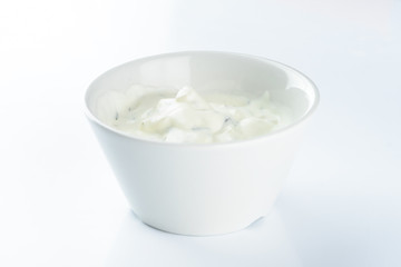 cream sauce with pickles in a bowl on a light background, mayonnaise