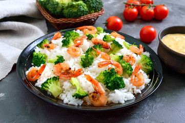 Rice with broccoli, shrimps and cream cheese sauce. Healthy and tasty food. Proper nutrition. Sports diet.