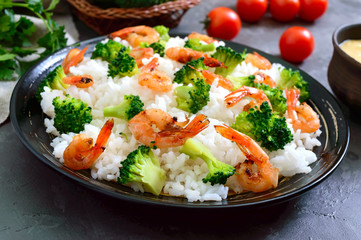 Rice with broccoli, shrimps and cream cheese sauce. Healthy and tasty food. Proper nutrition. Sports diet.