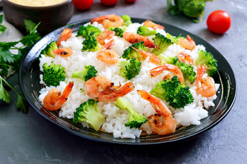 Rice with broccoli, shrimps and cream cheese sauce. Healthy and tasty food. Proper nutrition. Sports diet.