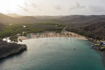 Aerial view of coast of Curaçao in the Caribbean Sea with turquoise water, cliff, beach and beautiful coral reef around Playa Sta. Cruz