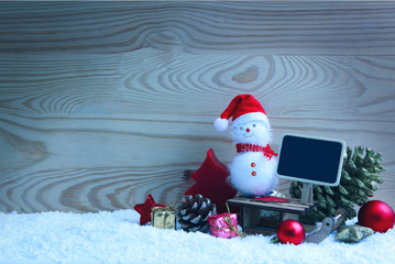Christmas snowman with red scarf and santa claus hat isolated .