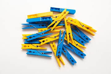 multi-colored plastic clothespins on white background