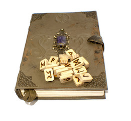 Vintage book with scattered runes