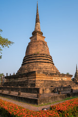Naklejka premium A brick chedi of Wat Sa Si, with hedges of flowers around the perimeter 