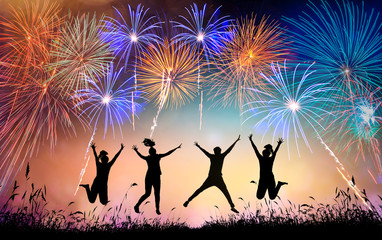 A group of teens jumping with fun and watching the fireworks