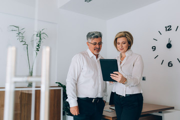 businesspeople using tablet computer in office