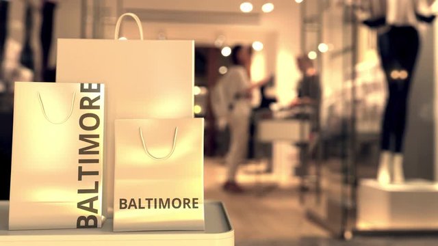 Shopping bags with Baltimore caption against blurred store entrance. Shopping in the United States related 3D animation