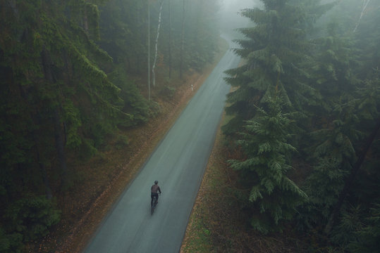 Luftaufnahme von Rennradfahrer bei Nebel im Wald
